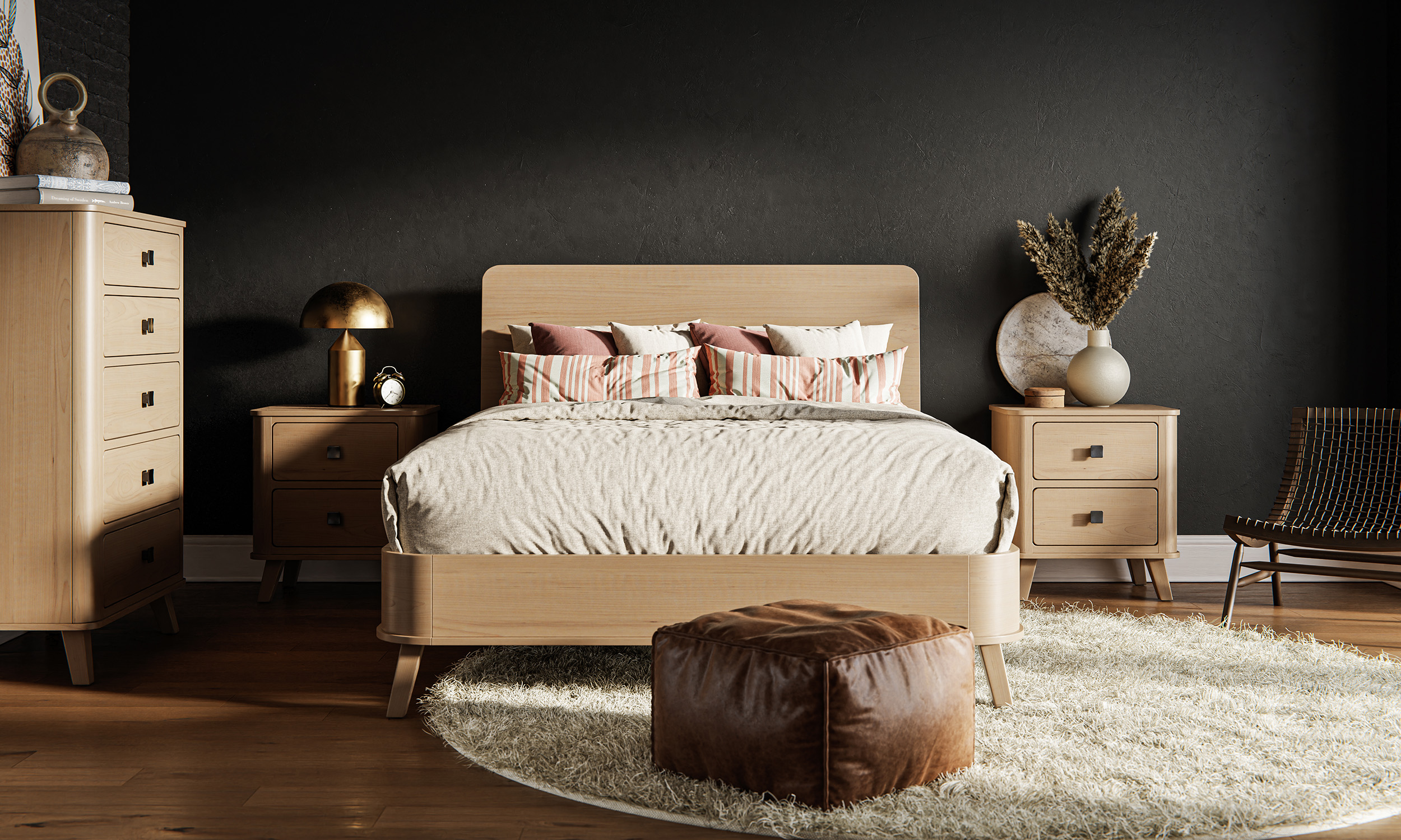 A modern bedroom with a light wooden bed, flanked by matching nightstands, and a chest of drawers. The bed is adorned with decorative pillows, and a round rug and leather ottoman are placed at the foot.