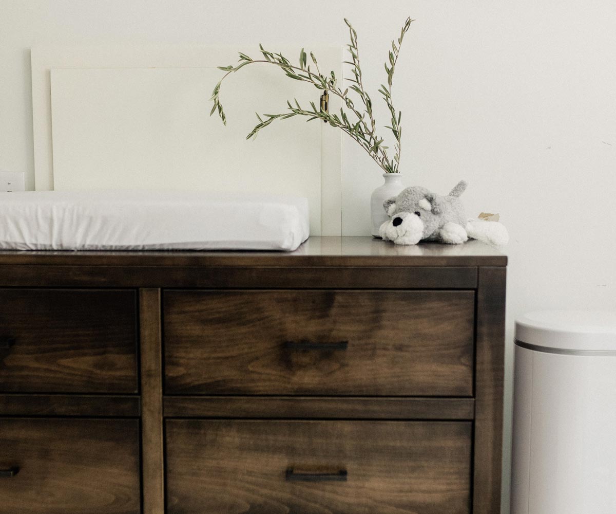 Photo used in best Amish furniture websites guide showing rustic nursery dresser with changing pad